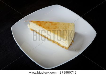 milk cake sweet food / piece of dessert delicious top view milk cake vanilla slice on white plate on the table black background