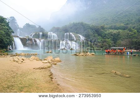 Cao Bang, Vietnam - Nov 30, 2018 : Tourist Visiting Ban Gioc Waterfall Or Detian Falls By Bamboo Boa