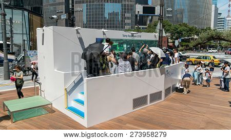 Tokyo, Japan - August 2018: Sony Aquarium Infront Of Ginza Sony Park With Tropical Fish And People W