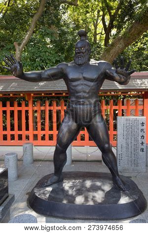 Fukuoka, Japan - October 20, 2018: Statue of a sumo wrestler of ancient times at the Sumiyoshi shrine grounds
