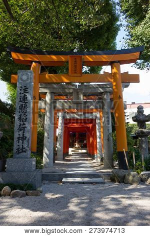 Fukuoka, Japan-October 19, 2018: Entrance with red torii to a shrine at the Kushida ninja shrine grounds