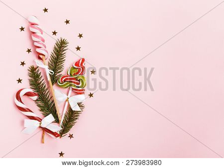Christmas Composition. Xmas Pink Decor, Christmas Candy Cane With Ribbon On Pink Background.