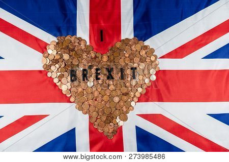 Brexit Concept Union Jack And Eu Flag Separated.piggy Coin Bank On Side,1p And 2p Coins.