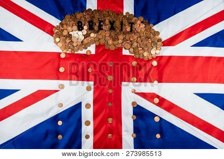 Brexit Concept Union Jack And Eu Flag Separated.piggy Coin Bank On Side,1p And 2p Coins.