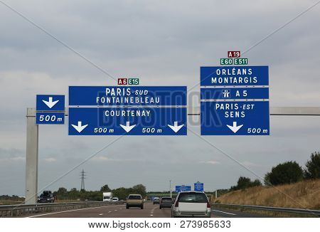 Big Road Signs On The Busy French Highway To Go To Paris And To The Other Indicated Locations