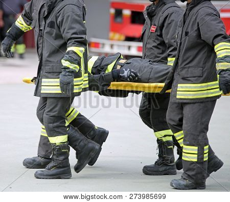 Firefighters Carry A Wounded Man On A Stretcher During An Exercise