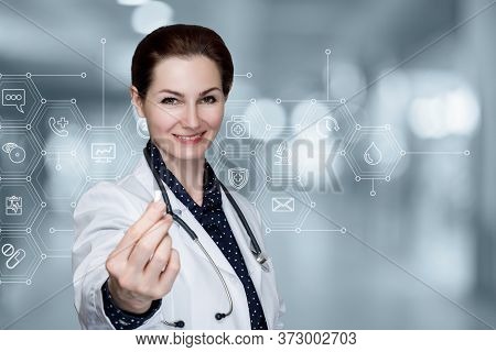 Female Doctor Shows Medicine In Pill Form On Blurred Background.