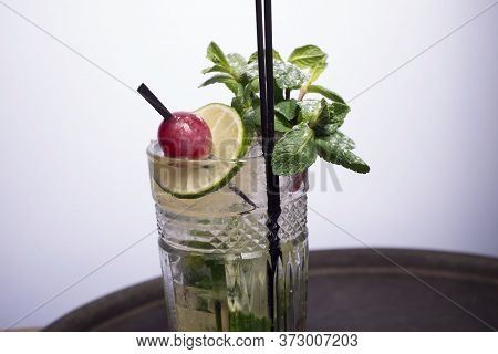 Close-up, Advertising Shot Of A Light Alcoholic Cocktail, With A Sprig Of Mint, Icing Sugar, With De