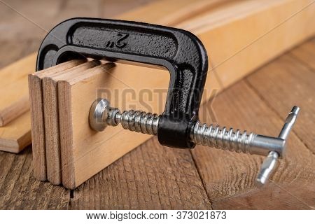 Carpentry Clamp Used For Gluing Wood. Carpentry Accessories In A Home Workshop.