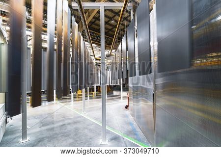 Powder Coating Line. Metal Panels Are Suspended On An Overhead Conveyor Line. Painting Products In A