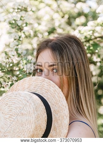 Portrait Of Beautiful Hipster Woman In Blooming Bush With White Flowers Of Spirea. Copy Space. Styli