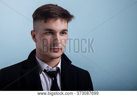 Portrait Of Young Handsome Man With Attentive Look On Greyish Blue Background. Trendy Hairstyle, Exp
