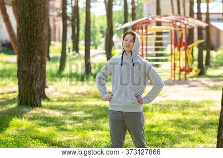 Single Young Man Doing Exercises In The Forest Park, Street Workout. Fitness Outside. Exercising Alo