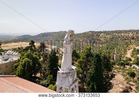 Abu Ghosh, Israel, June 13, 2020 : Statue Of The Mother Of God With A Baby In Her Arms On The Roof O