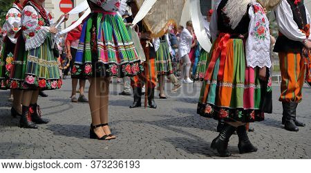 Local People In Traditional Folk Costumes From Lowicz, Poland, While Join Corpus Christi Procession
