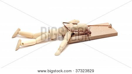 Wooden Doll Captured In Mousetrap