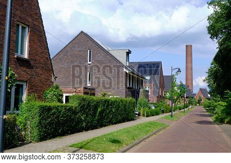 Street, New Houses, Old Enka Factory Site Old Chimney. New Residential Area After Soil Remediation. 