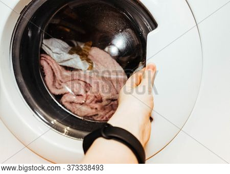 Laundry. Wash Clothes In The Washing Machine.getting Clothes Out Of The Wash