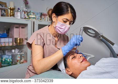 Face Skin Care. Close-up Of Woman Getting Facial Hydro Microdermabrasion Peeling Treatment At Cosmet