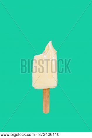 Milk Shake Popsicle With Couple Of Bites On A Green Background