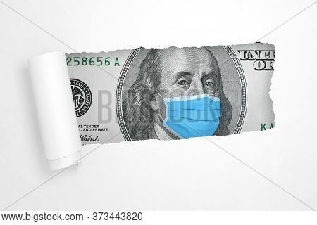 Benjamin Franklin With Medical Face Mask On A Hundred Dollar Bill In The Hole Of Torn White Paper Ex