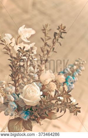 Vintage Photo Of A Beautiful Bouquet With White Roses, Blue Delphiniums, And Greenary