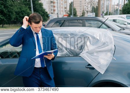 A Man Writes In A Tablet Next To The Car. An Accident On The Road, The Airbag Didnt Work.
