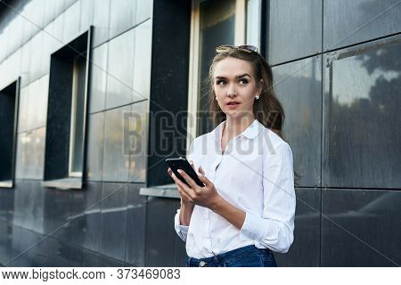The Business Girl With Phone. The Girl Gets A Plessure Message.