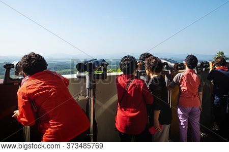 Dora Observatory, Dmz, South Korea - September 8 2017: Visitors Watching With Binoculars To North Ko