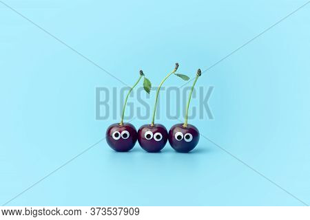 Cherry With Eyes On A Blue Background. Funny Vegetables And Fruits For Children. Baby Food Concept, 