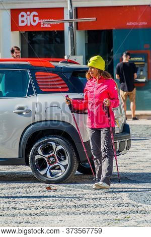 Leiria, Portugal - October 12, 2017: Woman With Ski Poles At Praca Rodrigues Lobo Square In Leiria