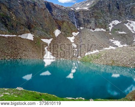 Reflection In The Lake And Snow On The Mountains