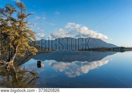 Lake Landscape With Mountain Hills And Reflection In Still Water. Lake Brunner Landscape With Mirror