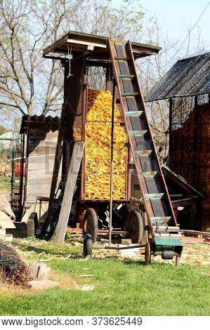 Vintage Retro Old Partially Rusted Inclined Belt Conveyor System On Small Wheels Used To Transport C