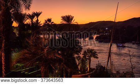 Nile River Bank In Egypt Sunset Orange Sky And Palm Tree With Sand Dessert Slope