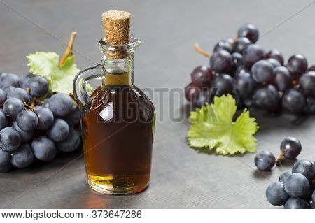 Glass Bottle Of Organic Black Grape Balsamic Vinegar Made From Fermented Fresh Grapes. Healthy Organ