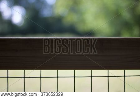Background Showing Blurred Greenery Behind Wooden Fence With Copy Space