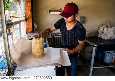 Young Man Selling Tortillas Of Nixtamal