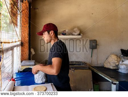 Young Man Selling Tortillas Of Nixtamal