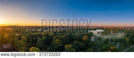 Fog In Munich. Misty Aerial View In The Popular Englischer Garten And A Total View Ovewr The Skyline