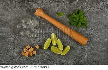 Close Up Mojito Cocktail Ingredients Set Flat Lay, Wooden Muddler, Brown Sugar, Heap Of Fresh Green 