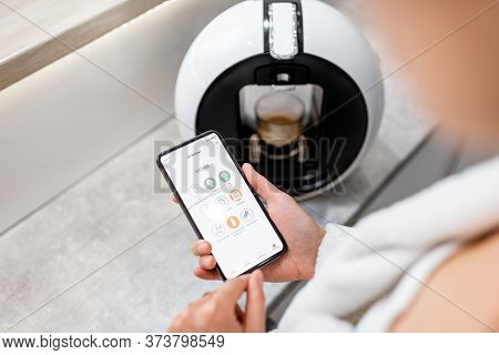 Cotrolling Coffe Machine With A Smart Phone, Close-up On Phone With Launched Smart Home Application