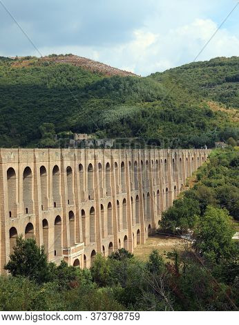 Imposing Structure Of The Aqueduct Called Carolino Aqueduct Near The Royal Palace Of Caserta In Sout