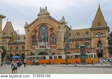 Budapest, Hungary - July 13, 2015: Central Market Hall At Fovam Square With People And Tram Public T