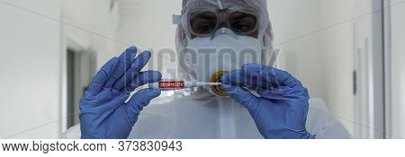 Scientist In Protective Gear With Arms Crossed In Laboratory
