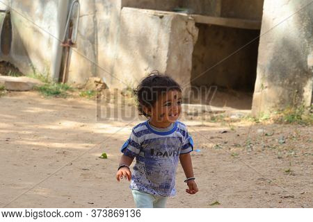 Raipur, Rajasthan , India,‎14 ‎march ‎2020,a Small Child Is Laughing And Walking, With Black Kajal D