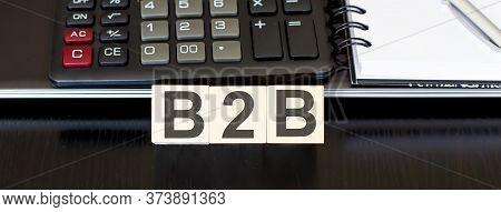 Business Concept Text On Wood Block B2b With Calculator, Notebook And Laptor