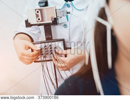 Doctor And Patient With Encephalography Electrode. Electroencephalogram