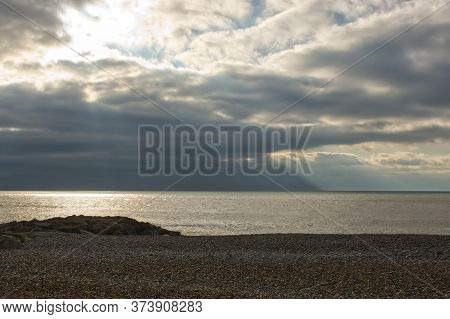Shingle Beach At Rottingdean, Near Brighton, East Sussex, England. With Stormy Sky