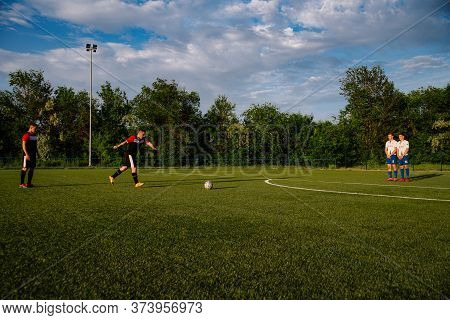 Soccer Player Kicks The Ball.soccer Player Takes The Free-kick.